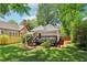 Charming backyard with a wooden deck, lush green lawn, mature trees, and a privacy fence at 34 Clifton Se St, Atlanta, GA 30317