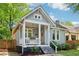 Charming home featuring light gray siding, a cozy porch swing, and well-manicured landscaping at 34 Clifton Se St, Atlanta, GA 30317