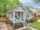 Charming home featuring light gray siding, a cozy porch swing, and well-manicured landscaping at 34 Clifton Se St, Atlanta, GA 30317