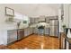 Modern kitchen with gray cabinets, stainless steel appliances, granite countertops, and hardwood floors at 34 Clifton Se St, Atlanta, GA 30317