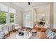 Inviting living room with hardwood floors, large windows, and open layout to dining area at 34 Clifton Se St, Atlanta, GA 30317
