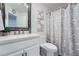 Bright bathroom with a quartz vanity, large mirror, and stylish floral-patterned shower curtain at 351 Gaines St, Marietta, GA 30060