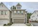 Two-story home featuring a two-car garage, neat landscaping, and light brown siding at 351 Gaines St, Marietta, GA 30060