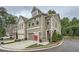 Corner lot property with a two-car garage, manicured lawn, and sidewalk access at 351 Gaines St, Marietta, GA 30060
