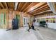 Unfinished basement space with exercise equipment, featuring exposed beams and natural light from large windows at 4470 Crestwicke Pointe, Atlanta, GA 30319