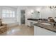 Bathroom showcasing white vanity, shower, marble countertops, and a large tub at 4470 Crestwicke Pointe, Atlanta, GA 30319