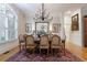 Bright dining room featuring hardwood floors, natural light, a large table, and a decorative chandelier at 4470 Crestwicke Pointe, Atlanta, GA 30319