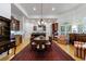 Elegant dining room with hardwood floors, a chandelier, and seamless flow into the adjacent kitchen at 4470 Crestwicke Pointe, Atlanta, GA 30319