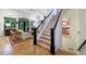 Inviting foyer with hardwood floors, staircase, and large windows providing natural light and a view to the living room at 4470 Crestwicke Pointe, Atlanta, GA 30319