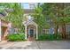 Elegant brick home featuring a welcoming front entrance with a covered porch and lush landscaping at 4470 Crestwicke Pointe, Atlanta, GA 30319