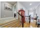 Upper hallway featuring hardwood floors, a staircase with black handrail and art hung on the painted walls at 4470 Crestwicke Pointe, Atlanta, GA 30319
