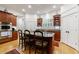 Well-appointed kitchen island featuring a granite countertop, seating, and ample storage within custom cabinetry at 4470 Crestwicke Pointe, Atlanta, GA 30319