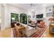 Bright living room featuring a fireplace, built-in shelving, and large windows with transoms overlooking the yard at 4470 Crestwicke Pointe, Atlanta, GA 30319