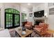 Cozy living room showcasing a fireplace, built-in shelving, and French doors leading to an outdoor space at 4470 Crestwicke Pointe, Atlanta, GA 30319