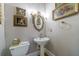 Traditional powder room with pedestal sink, ornate mirror, toilet, and floral paintings at 4470 Crestwicke Pointe, Atlanta, GA 30319