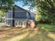 Backyard featuring a well-maintained lawn, wooden fence, and a view of the home's exterior at 845 Heritage Dr, Stone Mountain, GA 30088