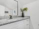 Bright bathroom vanity featuring granite counters, updated fixtures, and a decorative mirror at 845 Heritage Dr, Stone Mountain, GA 30088