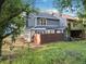 Backyard showing the exterior of the home, grass, trees, and a fence at 845 Heritage Dr, Stone Mountain, GA 30088