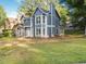 Inviting two-story home featuring blue siding, white trim windows, and a well-manicured front lawn at 845 Heritage Dr, Stone Mountain, GA 30088