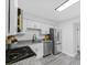 Well-lit kitchen with stainless steel appliances, granite countertops, and white cabinetry at 845 Heritage Dr, Stone Mountain, GA 30088