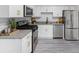 Modern kitchen with stainless steel appliances, white cabinets, and granite countertops at 845 Heritage Dr, Stone Mountain, GA 30088