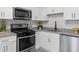 Kitchen with white cabinets, stainless steel appliances, and subway tile backsplash at 845 Heritage Dr, Stone Mountain, GA 30088