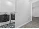 Laundry room with front load washer/dryer and geometric patterned tile flooring at 845 Heritage Dr, Stone Mountain, GA 30088