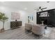 Open-concept living room featuring a black fireplace and sleek gray laminate flooring at 845 Heritage Dr, Stone Mountain, GA 30088