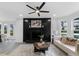Bright living room featuring a modern ceiling fan and black fireplace with decorative accents at 845 Heritage Dr, Stone Mountain, GA 30088