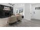 Open-concept living room with fireplace and sleek gray laminate flooring at 845 Heritage Dr, Stone Mountain, GA 30088