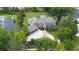 Aerial view of large brick home with sprawling backyard, mature trees, manicured landscaping, and long driveway at 22 Mount Paran Rd, Atlanta, GA 30327