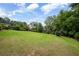 Spacious backyard with lush green lawn, mature trees, and manicured landscaping, providing a serene outdoor space at 22 Mount Paran Rd, Atlanta, GA 30327