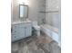 Beautiful bathroom with marble countertop, white cabinets, tub with marble tile, and luxury vinyl tile flooring at 22 Mount Paran Rd, Atlanta, GA 30327