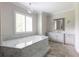 Bathroom features a large tub, marble countertops, tiled floors, and a bright window at 22 Mount Paran Rd, Atlanta, GA 30327