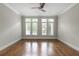 Empty bedroom features hardwood floors, high ceilings, and many windows with shutters at 22 Mount Paran Rd, Atlanta, GA 30327