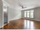 Spacious bedroom with a ceiling fan, hardwood floors, white trim and plantation shutters on the windows at 22 Mount Paran Rd, Atlanta, GA 30327