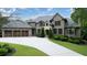 Charming two-story brick home with three-car garage, manicured lawn and a stone archway entrance at 22 Mount Paran Rd, Atlanta, GA 30327