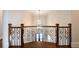 Grand foyer with iron railing, hardwood floors and a decorative hanging light fixture at 22 Mount Paran Rd, Atlanta, GA 30327
