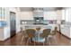 Bright kitchen with white cabinets, stainless steel appliances, large island, and hardwood floors at 22 Mount Paran Rd, Atlanta, GA 30327