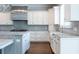 Spacious kitchen with custom white cabinetry, farm sink and granite countertops at 22 Mount Paran Rd, Atlanta, GA 30327