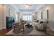 Comfortable living room with hardwood floors, fireplace, tray ceiling, bay window, and ample seating at 22 Mount Paran Rd, Atlanta, GA 30327