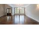 Open living room featuring wood floors, large windows, and elegant lighting at 22 Mount Paran Rd, Atlanta, GA 30327