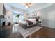 Spacious main bedroom with hardwood floors, tray ceiling, and a cozy seating area by the window at 22 Mount Paran Rd, Atlanta, GA 30327