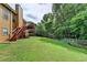 Spacious backyard featuring a deck, large yard, wooden fence, and mature trees, ideal for entertaining and outdoor enjoyment at 2694 Sterling Dr, Lawrenceville, GA 30043