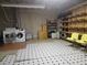 Unfinished basement with laundry, storage shelves and potential for customization at 2694 Sterling Dr, Lawrenceville, GA 30043
