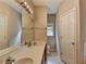 Bathroom with double sinks, vanity lighting, and ceramic tile flooring at 2694 Sterling Dr, Lawrenceville, GA 30043