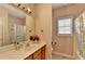 Bright bathroom with a large mirror, wood cabinets, and a shower/tub combo at 2694 Sterling Dr, Lawrenceville, GA 30043