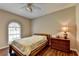 Relaxing bedroom with wood floors, a large window, a dresser, and a ceiling fan at 2694 Sterling Dr, Lawrenceville, GA 30043