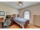Comfortable bedroom featuring a ceiling fan, wood floors, and an arched window at 2694 Sterling Dr, Lawrenceville, GA 30043