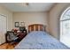 Bedroom with hardwood floors, closet, arched window, desk, and ceiling fan at 2694 Sterling Dr, Lawrenceville, GA 30043